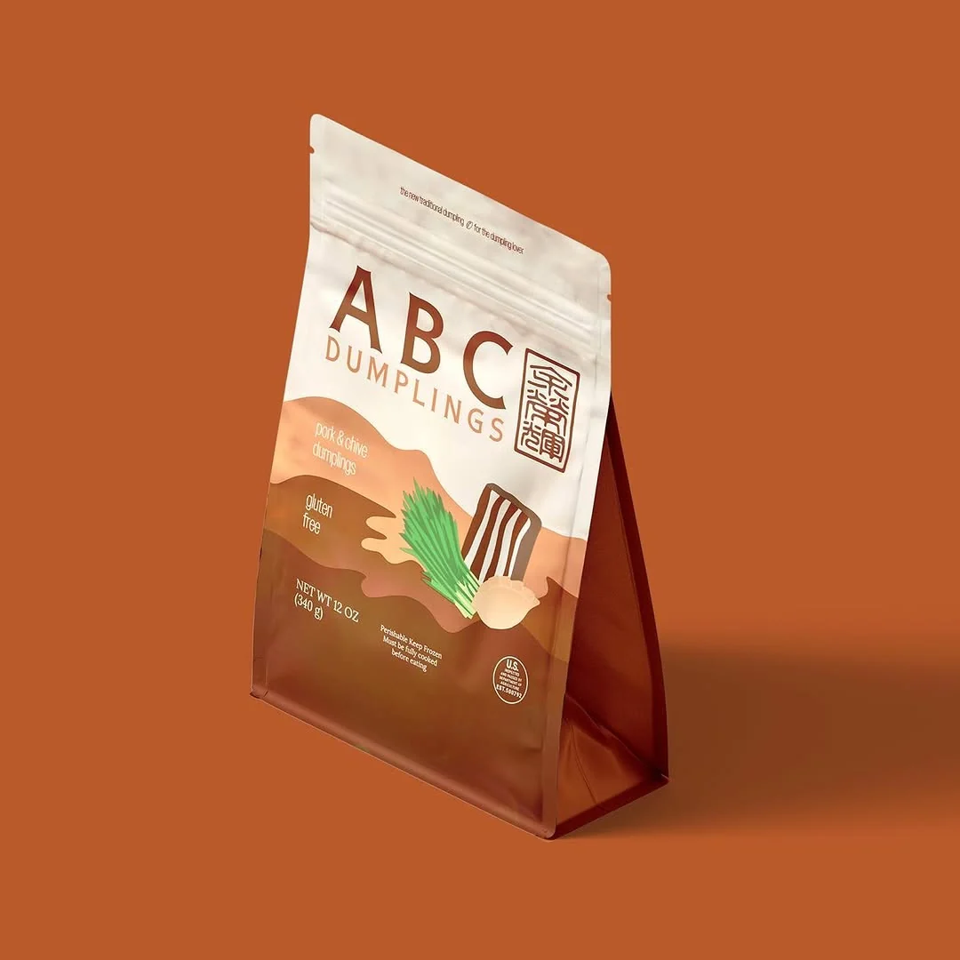 Organic pork and chive ABC Dumplings pack on an orange background