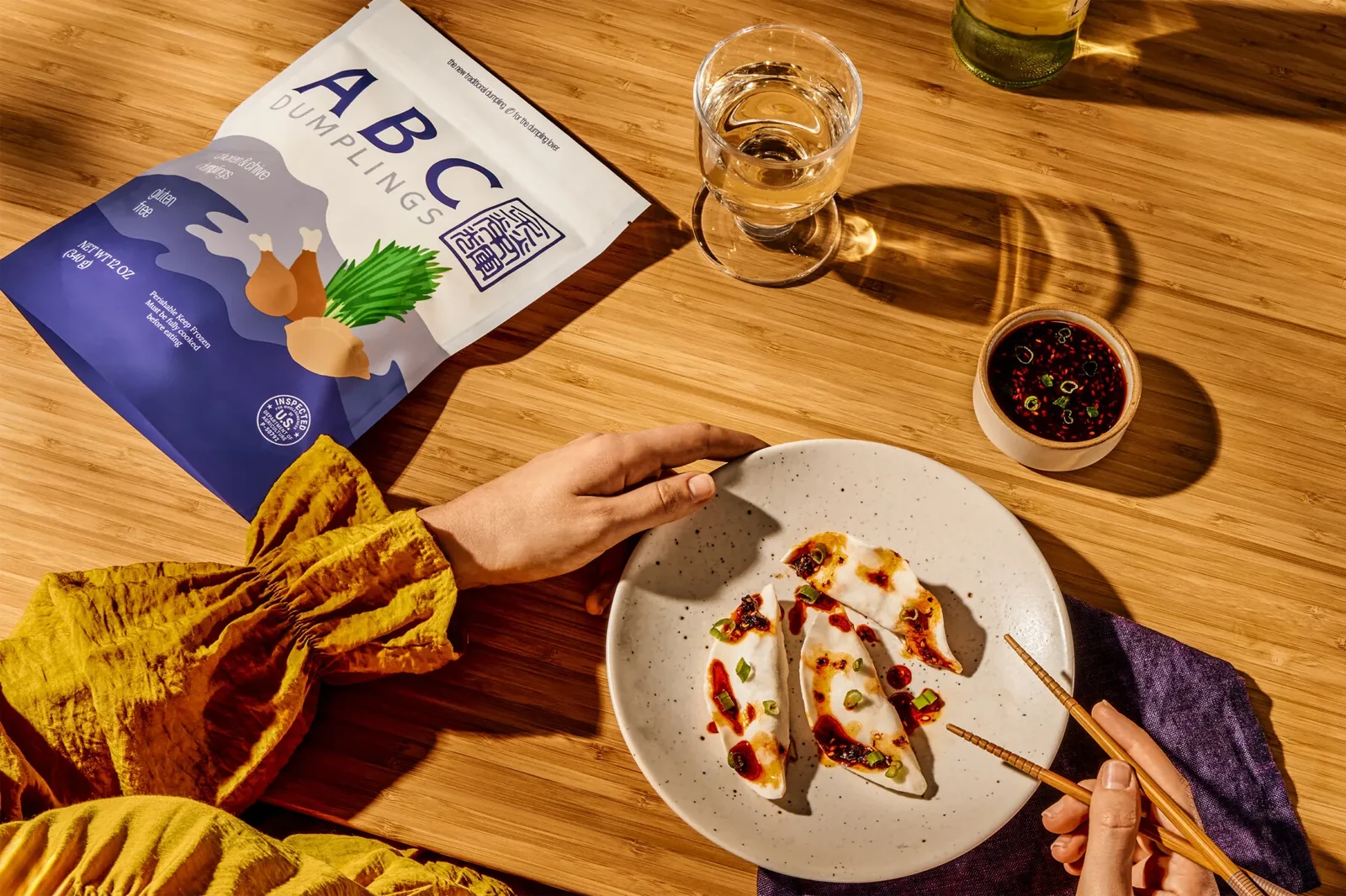 Warm table setting with ABC Dumplings and sauce bowls