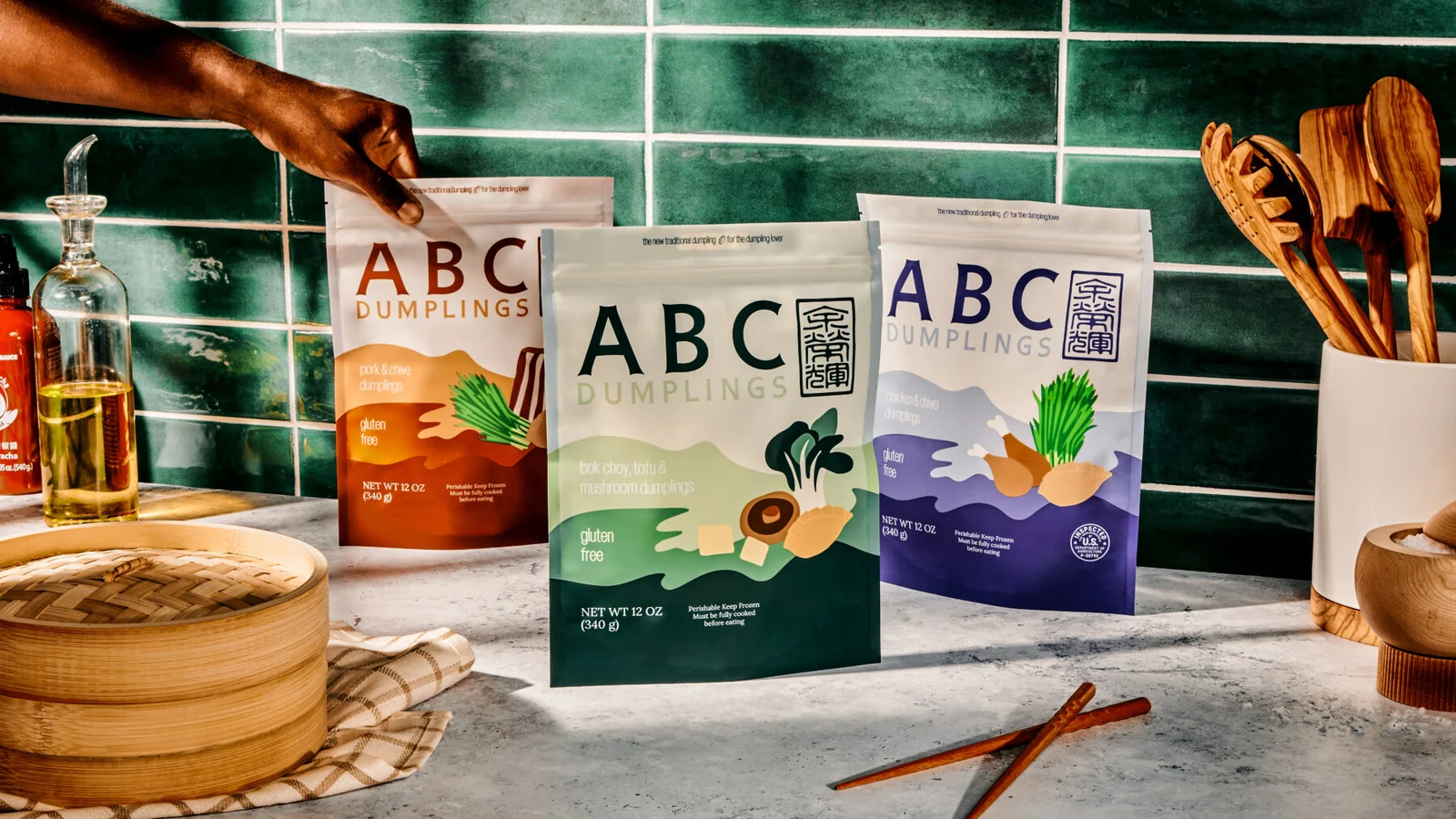 ABC Dumplings bags and plated dumplings on a kitchen counter